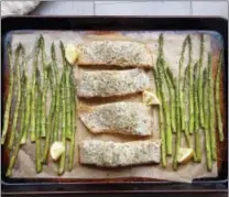  ?? MELISSA D’ARABIAN VIA AP ?? This photo shows a sheet-pan supper of salmon and asparagus in Coronado a recipe by Melissa d’Arabian.