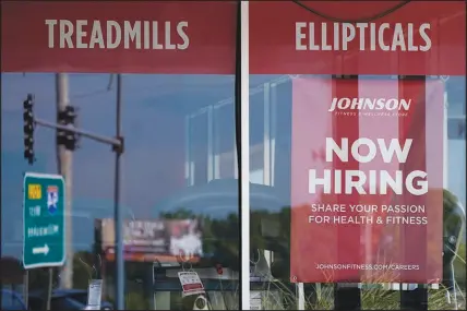  ?? NAM Y. HUH / AP ?? Hiring sign are displayed Sept. 21 in Northbrook, Ill. The federal government reports that weekly applicatio­ns for jobless aid have dropped to a five-month low, which means that in the midst of a labor shortage, few employers are resorting to layoffs.