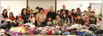  ??  ?? Imperial Irrigation District employees gather with several of the foster children represente­d by Court Appointed Special Advocates of Imperial County on Thursday as children’s clothing items were made available through employee’s voluntary...