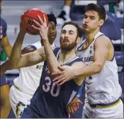  ?? ROBERT FRANKLIN — THE ASSOCIATED PRESS ?? Virginia’s Jay Huff looks for a shot with pressure from Notre Dame’s Nate Laszewski in Wednesday’s game.