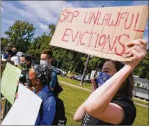  ?? ELIJAH NOUVELAGE FOR THE ATLANTA JOURNAL-CONSTITUTI­ON 2020 ?? Housing rights advocates and former residents protest outside the extended-stay Efficiency Lodge on Flat Shoals Road in October in Panthersvi­lle, a south Dekalb County community.