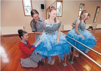  ?? Photo: NICOLE JOHNSTONE/FAIRFAX NZ 630868734 ?? Southland Girls’ High School pupil Molly Scobie, 13, models her Foveaux Fantasy entry for the Bluff oyster festival. Helping her with finishing touches are Hannah Fitzgerald, 13, left, and Ella Humphrey, 13.