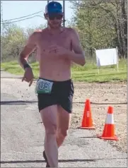  ?? Photo by Karen Wages ?? Josh Snyder crosses the finish line as the winner of the Cavanal Killer 8K on Saturday.