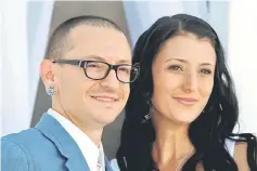  ??  ?? Bennington and wife Talinda arrive at the 2012 Billboard Music Awards in Las Vegas, Nevada. (Right, top) Members of Linkin Park (left to right) Shinoda, Rob Bourdon, Joe Hahn, Brad Delson, Dave Farrell and Bennington put their handprints in cement as...