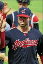  ?? TIM PHILLIS — THE NEWS-HERALD ?? Indians pitcher Corey Kluber gives high-fives to his teammates after pitching a complete game against the Yankees.