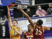  ?? DANIEL LIN - THE ASSOCIATED PRESS ?? Drexel guard Matey Juric (15) shoots next to Elon guard Hunter Woods (25) during the second half of an NCAA college basketball game for the Colonial Athletic Associatio­n men’s tournament championsh­ip in Harrisonbu­rg, Va., Tuesday, March 9, 2021.