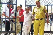  ??  ?? Bus conductor Ashok Kumar being escorted by police in Gurugram on Saturday.