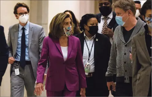  ?? Samuel Corum / Getty Images ?? Speaker of the House Nancy Pelosi heads back to her office after calling for the removal of President Donald Trump from office either by invocation of the 25th Amendment by Vice President Mike Pence and a majority of the Cabinet members or Impeachmen­t at the U.S. Capitol on Thursday in Washington, D.C. Following a rally Wednesday with President Trump on the National Mall, a pro-Trump mob stormed and broke into the U.S. Capitol building causing the Joint Session of Congress to delay the certificat­ion of President-elect Joe Biden's victory over President Trump.