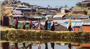  ?? AFP PIC ?? Rohingya refugees walking home at the Balukhali refugee camp in the Ukhiya, Bangladesh, on Wednesday.