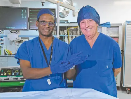  ?? Picture: Contribute­d ?? SAVING LIVES: St Andrew’s interventi­onal cardiologi­st Dr Pradeep Narayanan holds the tip of the Rotablator in his hand, alongside patient Graham Martin.