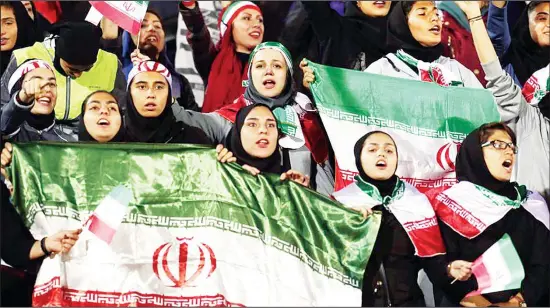  ??  ?? In this file photo, female Iranian spectators cheer during a friendly football match between Iran and Bolivia at the Azadi (Freedom) Stadium in Tehran, Iran on Oct 16, 2018. (AP)