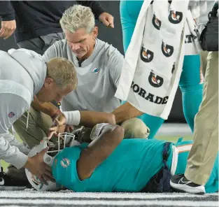  ?? TRIBUNE CONTENT AGENCY ?? Miami Dolphins quarterbac­k Tua Tagovailoa shows a fencing response common to serious head injuries after a big hit against the Cincinnati Bengals in September. Tagovailoa was taken off on a stretcher and taken to a hospital after what appeared to be his second significan­t head injury in less than a week.