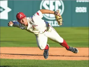  ?? CRAVEN WHITLOW/NATE Allen Sports Service ?? Razorback junior shortstop Robert Moore, 1, makes an acrobatic throw to first in a win against Grambling Wednesday afternoon at Baum-walker Stadium in Fayettevil­le. Moore had three hits and a home run in Arkansas’ 6-2 win over Kentucky in the SEC opener Friday at Baum.