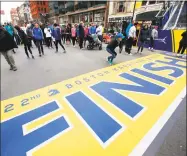  ?? Michael Dwyer / Associated Press ?? People gather at the Boston Marathon finish line on Sunday in Boston.