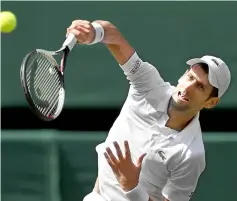  ?? — AFP photos ?? Djokovic serves to Japan’s Kei Nishikori during their men’s singles quarter-final match.