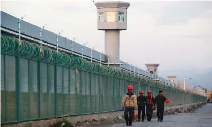  ??  ?? A re-education camp in Xinjiang, part of a network of control and surveillan­ce used against Muslims which also includes an app to track suspicious ‘person types’. Photograph: Thomas Peter/Reuters
