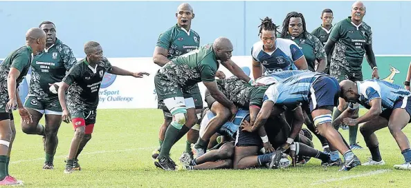  ?? Picture: RANDELL ROSKRUGE ?? DIGGING DEEP: A Swallows player digs out the ball out of a ruck while Winter Rose players line up in defence in their Border Super League clash at the Sisa Dukashe Stadium