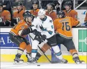  ?? Marcio Jose Sanchez Associated Press ?? THE DUCKS’ Chris Wagner, left, and Ryan Garbutt battle San Jose’s David Schlemko in the first period.