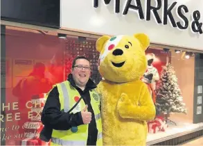  ??  ?? Pudsey Bear with Round Table member Charles Openshaw, collecting outside Marks &amp; Spencer in Southport