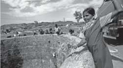  ?? RAJANISH KAKADE/AP FILE ?? People prepare to draw water from a dried-up well in Maharashtr­a state, India, in 2016 after a tanker emptied water into the well.