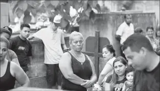  ??  ?? Relatives attend the burial of Wilmer Gerardo Nunez in San Pedro Sula, Honduras. An official report of the 2010 San Fernando ranch massacre stated that body No. 63 was a male with tattoos, one reading “Dachell.”