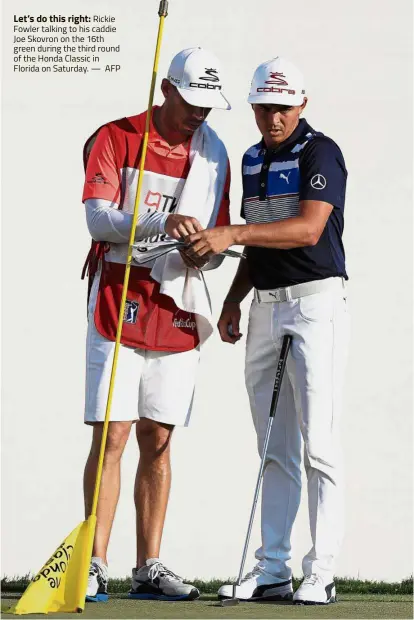  ??  ?? Let’s do this right:
Rickie Fowler talking to his caddie Joe Skovron on the 16th green during the third round of the Honda Classic in Florida on Saturday. — AFP