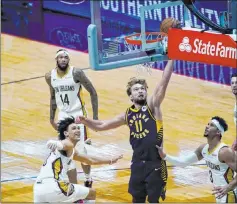  ?? Gerald Herbert The Associated Press ?? Pacers forward Domantas Sabonis (11) drives past Pelicans defenders Jaxson Hayes and Josh Hart (3) in the first half of Monday’s OT win.