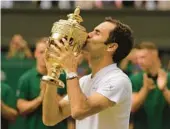  ?? AP FILE ?? Roger Federer kisses the trophy after winning his record eighth and final Wimbledon men’s singles title in 2017. Federer, 41, won a total 20 Grand Slam singles titles.