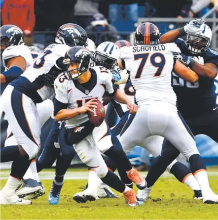  ?? Joe Amon, The Denver Post ?? Broncos quarterbac­k Trevor Siemian is forced out of the pocket during the fourth quarter against the Tennessee Titans on Sunday. Siemian completed 35-of-51 passes for 334 yards and a touchdown.