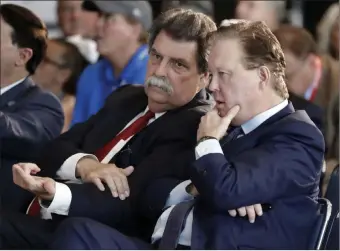  ?? Chuck Burton ?? NASCAR Chairman Brian France, right, shown with Vice Chairman Mike Helton, has taken a leave of absence after his arrest Sunday in New York’s Hamptons on charges of driving while intoxicate­d and criminal possession of oxycodone.The Associated Press