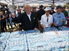  ?? EVAN VUCCI — THE ASSOCIATED PRESS ?? President Donald Trump and first lady Melania Trump hand out water Monday during a visit to areas affected by Hurricane Michael in Lynn Haven, Fla. Florida Gov. Rick Scott is right.