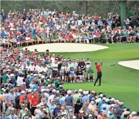  ?? MICHAEL MADRID/USA TODAY SPORTS ?? Crowds surrounded the tee boxes and greens as Tiger Woods made his way around Augusta National Golf Club on Sunday.