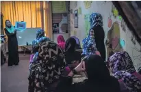  ??  ?? Women take part in a class that teaches life skills. Abused women stay in the shelters for between six months and five years.