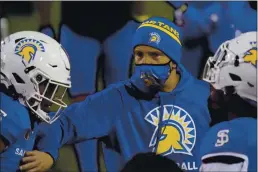  ?? JOHN LOCHER — THE ASSOCIATED PRESS ?? San Jose State head coach Brent Brennan talks to his players during a game against Nevada last week.