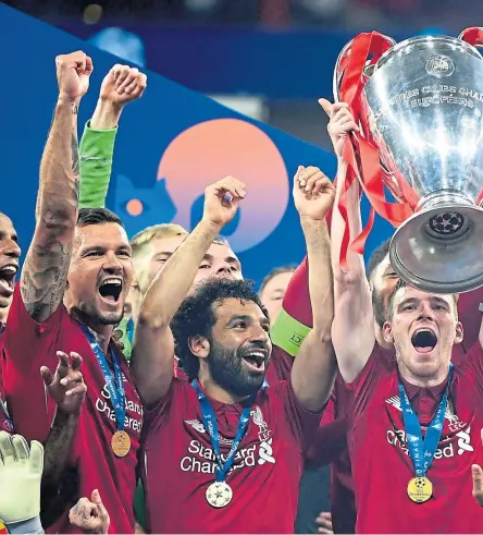  ??  ?? Scotland captain and former Dundee United full-back Andy Robertson holds the trophy aloft after Liverpool were crowned champions of Europe for a sixth time.