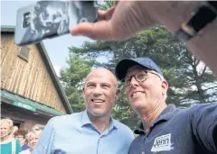 ?? AP ?? Michael Avenatti, left, an attorney and entreprene­ur, has a selfie taken with Mike Munhall at the Hillsborou­gh County Democrats’ Summer Picnic fundraiser in New Hampshire.
