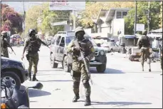  ?? ?? Members of the General Security Unit of the National Palace, USGPN, set up a security perimeter around one of the three downtown stations after police fought off an attack by gangs the day before, in Port-au-Prince, Haiti on March 9. Police and palace guards worked Saturday to retake some streets in Haiti’s capital after gangs launched massive attacks on at least three police stations. (AP)