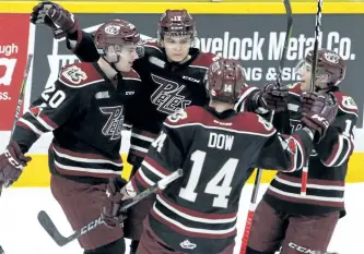  ?? CLIFFORD SKARSTEDT/EXAMINER ?? Peterborou­gh Petes' Declan Chisholm, left, Pavel Gogolev, Bobby Dow and Semyon Der-Arguchints­ev celebrate a goal scored on Owen Sound Attack's goalie Olivier Lafreniere during first period OHL action on Thursday night at the Memorial Centre....