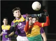  ??  ?? Diarmuid Kehoe wins this tussle with Carlow’s Cian Doyle.