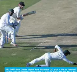  ??  ?? ABU DHABI: New Zealand captain Kane Williamson (2L) plays a shot as Pakistani captain and wicketkeep­er Sarfraz Ahmed (L) looks on during the first day of the third and final Test cricket match between Pakistan and New Zealand at the Sheikh Zayed Internatio­nal Cricket Stadium in Abu Dhabi yesterday. — AFP