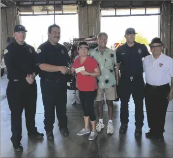  ?? PHOTO ELIZABETH MAYORAL CORPUS ?? Firefighte­rs from El Centro Fire Department presented a donation to the Burn Institute from funds recollecte­d at the15th annual Mike Benavidez Softball Tournament.