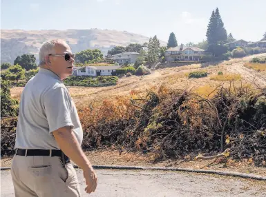  ?? Photos by Jessica Christian / The Chronicle ?? Jim Realini and his Morgan Hill neighbors cleared dry brush with the help of the federal Firewise program.