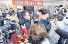  ?? THE PAPER ?? In an image from video, Li Jingwei, second from right, is reunited with his mother, center, and other relatives Jan. 1. Li was abducted by child trafficker­s when he was 4 years old.