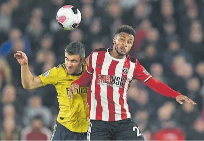  ?? Picture: AFP ?? LONE STRIKE. Sheffield United striker Lys Mousset (R) vies with Arsenal defender Sokratis Papastatho­poulos during their English Premier League match at Bramall Lane in Sheffield, England, last night.