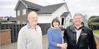  ??  ?? New look Ian Hyslop of Caledonian Windows admires Mr and Mrs Smith’s new roofline at their West Kilbride home