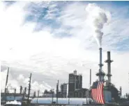  ?? THE ASSOCIATED PRESS FILE PHOTO ?? In this Sept. 6, 2017, file photo, a flag hangs on the side of the Andeavor Mandan Refinery in Mandan, N.D.