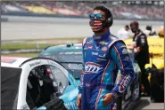  ?? (AP/John Bazemore) ?? NASCAR Cup Series driver Bubba Wallace surveys the empty grandstand before Monday’s race at Talladega Superspeed­way. The Justice Department said Tuesday there will be no federal charges after a noose was found in Wallace’s garage stall Sunday. The noose apparently had been there since at least October.