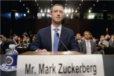  ?? AP PHOTO/ANDREW HARNIK FILE ?? FILE - In this April 10, 2018 file photo, Facebook CEO Mark Zuckerberg arrives to testify before a joint hearing of the Commerce and Judiciary Committees on Capitol Hill in Washington about the use of Facebook data to target American voters in the 2016 election. Some political die-hards are getting caught up in an expanded effort by Facebook and other social media companies to crack down on nefarious tactics suspected of interferin­g in the 2016 election. They have been flagged as “bots,” or robot-like automated accounts, because they tweet prolifical­ly.