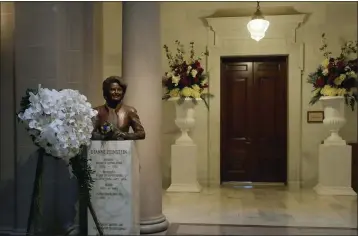  ?? JIM WILSON — THE NEW YORK TIMES ?? A wreath is shown next to the bust of Dianne Feinstein at City Hall in San Francisco following the announceme­nt of her death Sept. 29. Feinstein’s admirers have moved quickly to honor her accomplish­ments as the first woman to serve as mayor of San Francisco and the first woman to become a U.S. senator from California.