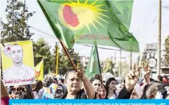  ??  ?? Syrian Kurds demonstrat­e against the Turkish assault in northeaste­rn Syria in the town of Qamishli yesterday. —AFP